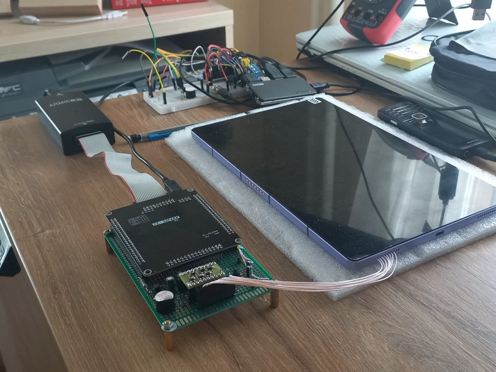 The wires from the tablet's holes are the test lines from the measuring device to the connection points on the motherboard