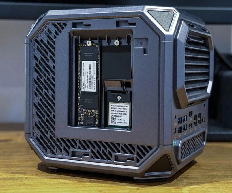   
Acemagic Tank 03 Mini-PC next to a gaming keyboard and mouse  
