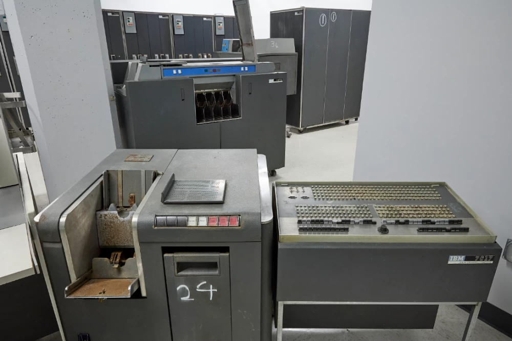 Collectible IBM 7090 mainframe against the background of historical documents