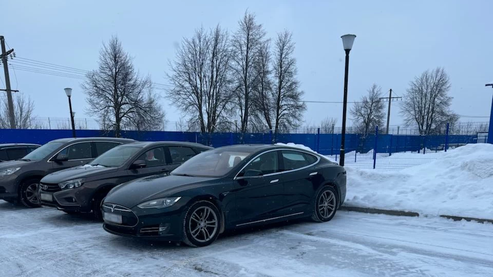 Tesla driving on a snowy road after repair