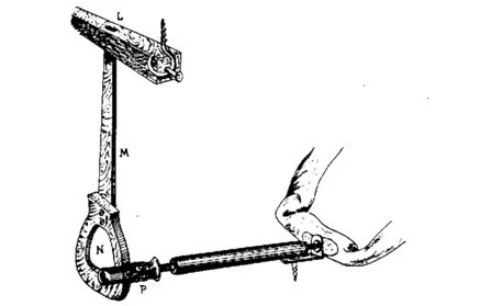 Mechanical parts for radio tubes, laid out on the table, 1920s workshop in France.