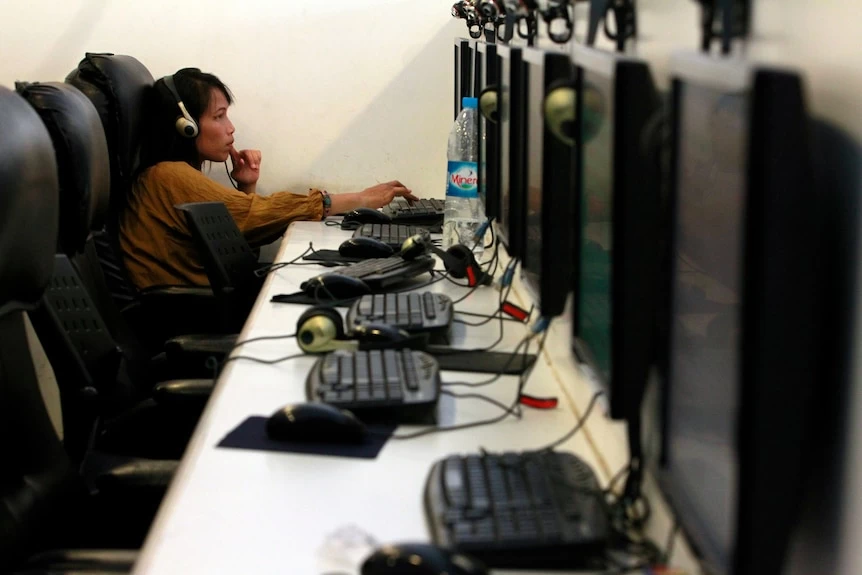 A woman works in an internet cafe.