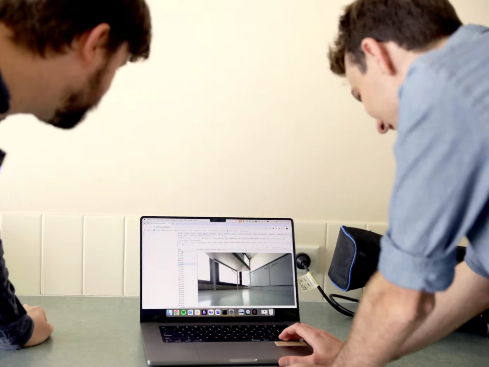 Showing Sean photos taken by his robot vacuum.