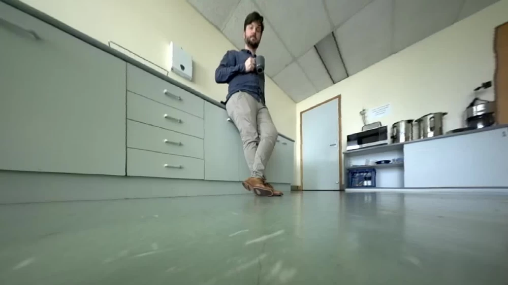 When the robot starts moving around the room to clean, Sean's face gets into the frame.