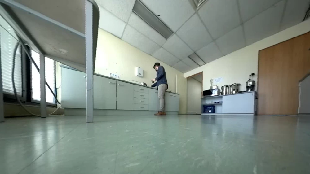 Upstairs, Sean is making himself a cup of coffee.