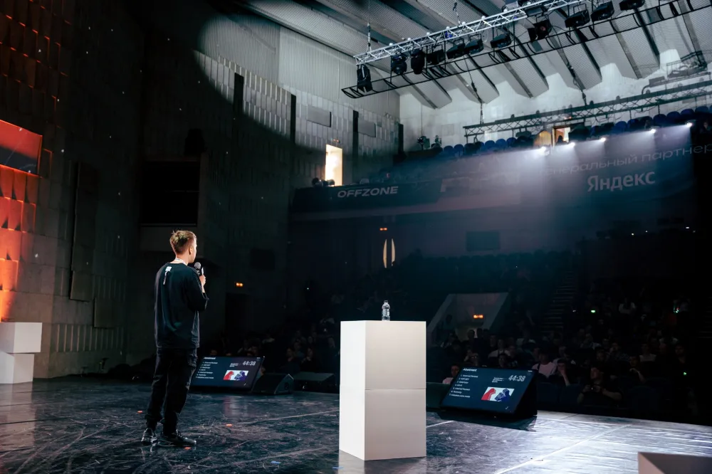 The OFFZONE speaker presents on stage after successfully passing the call for papers